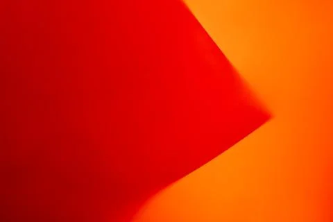 Red triangle on an orange background. Stock Photos