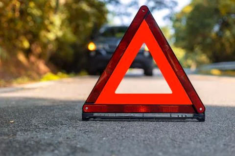 Red triangle, red emergency stop sign, red emergency symbol and black car sto Stock Photos