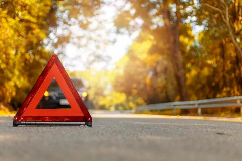 Red triangle, red emergency stop sign, red emergency symbol and black car sto Stock Photos