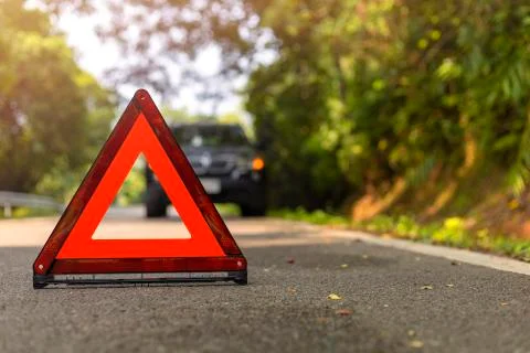 Red triangle, red emergency stop sign, red emergency symbol and black car sto Stock Photos