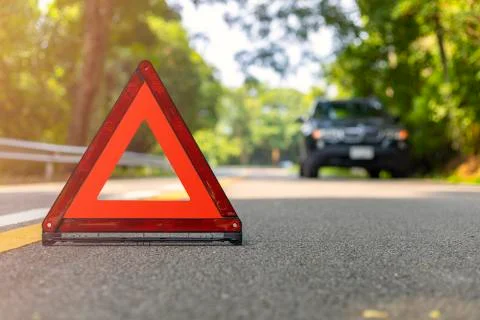 Red triangle, red emergency stop sign, red emergency symbol and black car sto Stock Photos