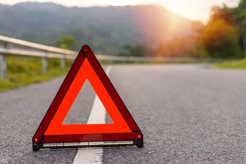 Red triangle, red emergency stop sign, red emergency symbol on road. With cop Stock Photos