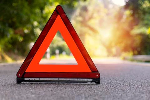 Red triangle, red emergency stop sign, red emergency symbol on road. Stock Photos