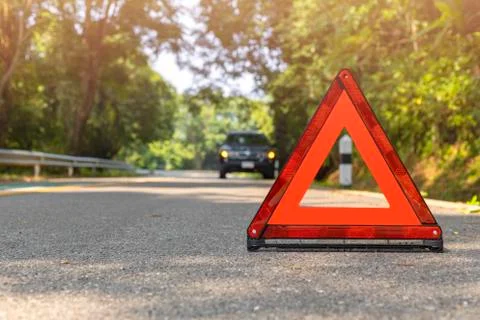 Red triangle, red emergency stop sign, red emergency symbol and black car sto Stock Photos