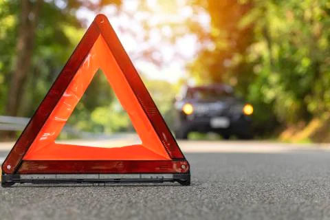 Red triangle, red emergency stop sign, red emergency symbol and black car sto Stock Photos