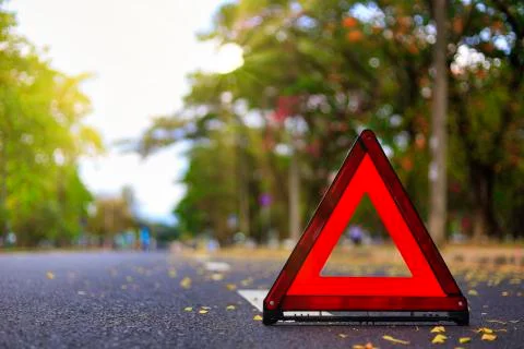 Red triangle, red emergency stop sign, red emergency symbol on road. With cop Stock Photos