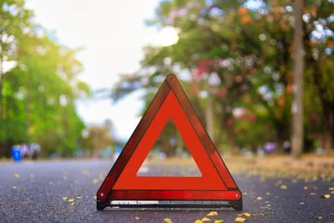 Red triangle, red emergency stop sign, red emergency symbol on road. With cop Stock Photos