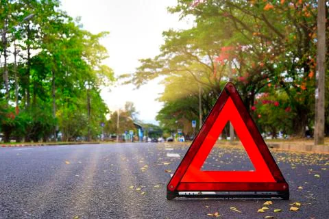 Red triangle, red emergency stop sign, red emergency symbol on road. With cop Stock Photos