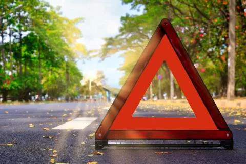Red triangle, red emergency stop sign, red emergency symbol on road. With cop Stock Photos