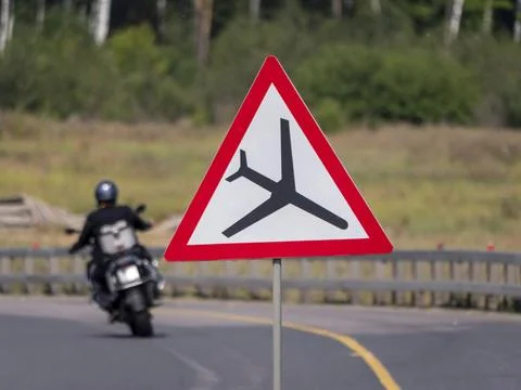 Red triangle warning sign cautioning that this is a low flying aircraft zone Stock Photos