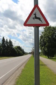 Red Triangular Deer Crossing Wildlife Warning Sign on Rural Countryside Road Stock Photos