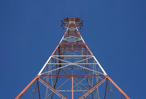 Red triangular power tower in the blue sky Stockfoto's