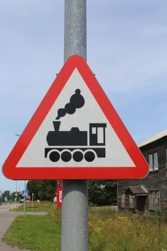 Red Triangular Railway Level Crossing Warning Sign with Steam Train Silhouette Stock Photos