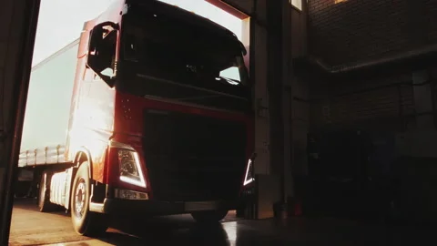 Red truck with cargo trailer pulls into a service station for annual service. Stock Footage 169944540