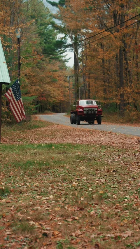 Red truck driving on a fall day Stock Footage 346252608