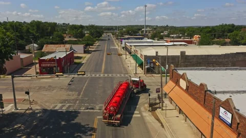 Red Truck making a turn at an intersection Stock Footage 156720994