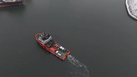 Red Tugboat Steering Through Calm Waters in Harbor Stock Footage 258145416