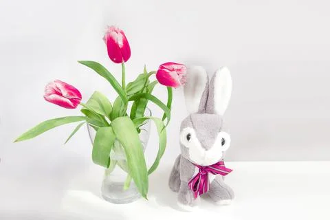 Red tulips flower and easter bunny on white Stock Photos