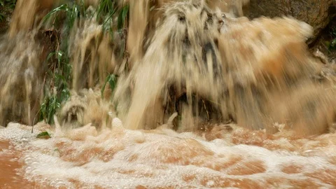 Red turbid water flows down from the mountain due to torrential rain Stock Footage 108548841