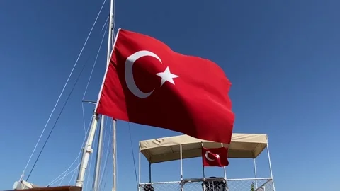 Red turkish flag with red and white moon waving on blue sky background Stock Footage 307698845
