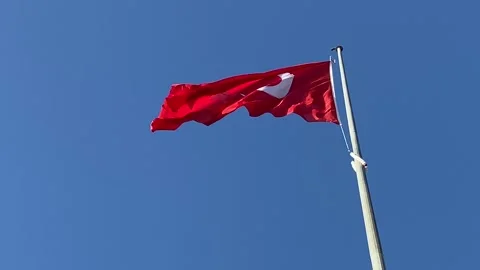 Red turkish flag with red and white moon waving on blue sky background, close Video stock 307698978