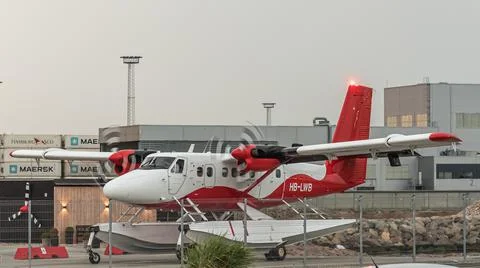 A red twin-engine seaplane on the ground Stock Photos