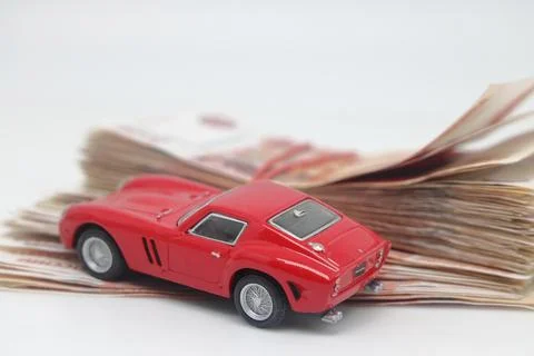 Red typewriter on five thousandth banknotes, car loan, car purchase. Stock Photos