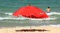 Red umbrella on the beach HD Footage