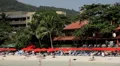 Red Umbrella on the beach, People Tanning, Kata Beach in Phuket Island HD Footage