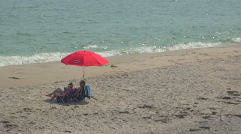 Red umbrella on Ho Hum beach on Fire Island Stock Footage 65451434