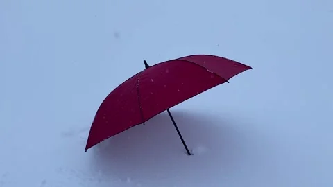 Red umbrella on the snow Stock Footage 148786584