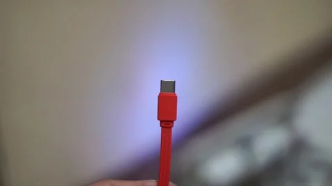 Red USB Type-C charging cable with a modern design for electronic devices Stock Footage 335591785