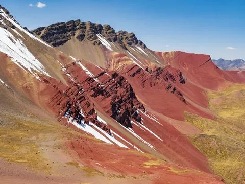 Red Valley with splashes of snow on the colored rocks, Cusco region, Peru Stock Photos