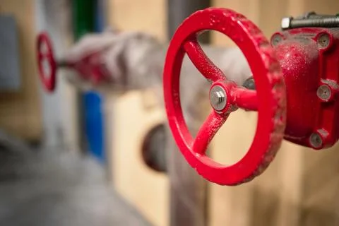 Red valves on hydrant pipelines of security and fire extinguishing systems of Foto stock