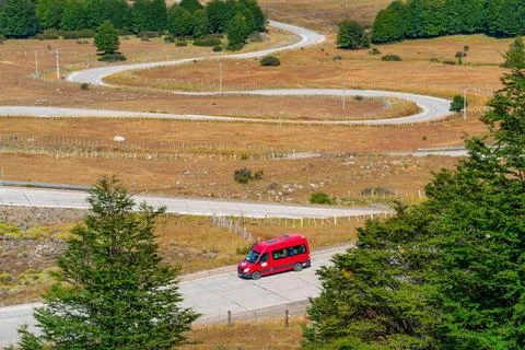 Red van in the Curvas del Diablo serpentines of the Carretera Austral also Stock Photos