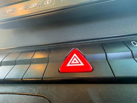 Red vehicle hazard warning button landscape 库存照片
