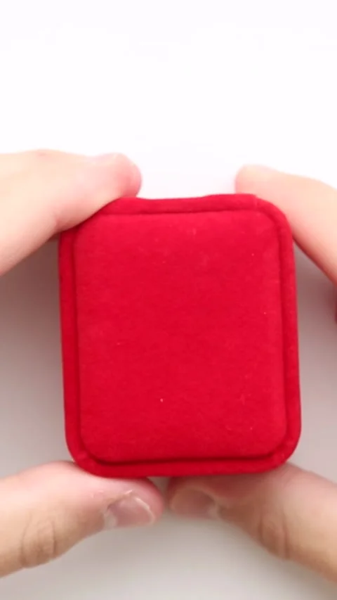 Red velvet ring box opens to reveal gold ring Stock Footage 316876043