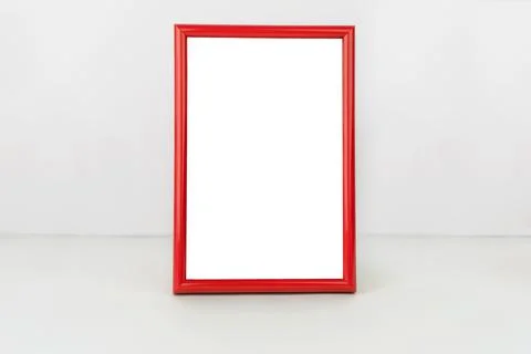 Red vertical frame on table. Isolated white background. Stock-Fotos