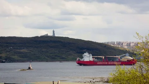 Red Vessel on River. Statue of Man on Hill. City Buildings on Othe Side. Time Stock Footage 71997737