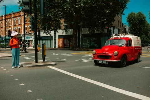 Red Vintage Van at Traffic Intersection in Chiswick, London Stock Photos