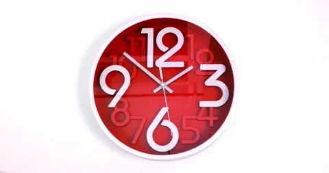 A red wall clock, isolated on a white background. Clock time ticking. Time lapse Stock Footage 216038164