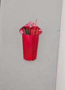 Red Wall Mounted Incense Holder With Burning Incense Sticks Fotos Stock