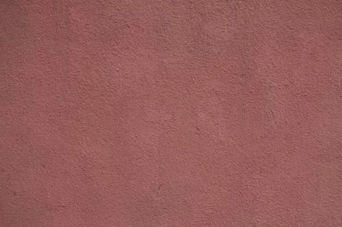 A red wall with a texture that looks like it's made of sand.  Stock Photos