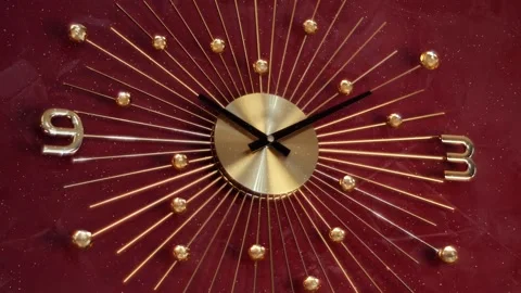 On the red wall there is a modern beautiful stylish chrome mechanical clock 库存影片 330870858