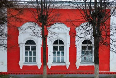 Red wall with three windows Stock Photos