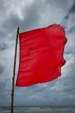 Red warning flag at a beach Stock Photos