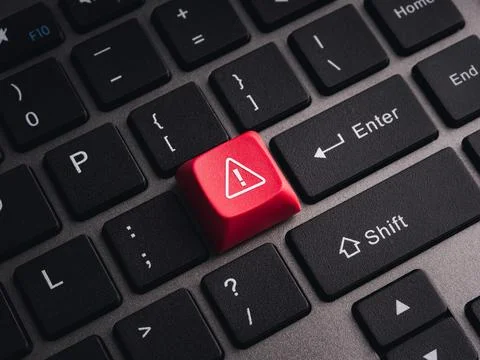 Red warning key on computer keyboard symbolizing cybersecurity threats, sys.. Stock Photos