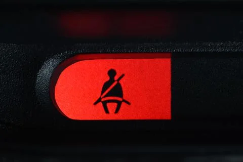 Red warning light on the car panel, not fastened with a seat belt. Close-up Stock Photos