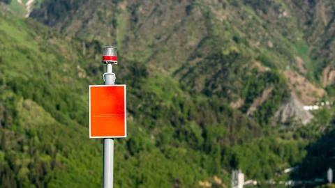 Red Warning Post with Light in Mountain Area Stock Photos