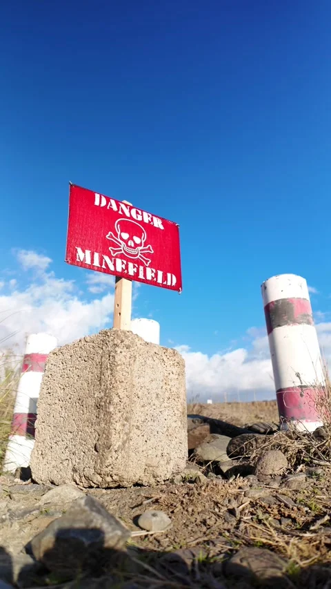 Red warning sign indicating a dangerous minefield Video stock 332164148